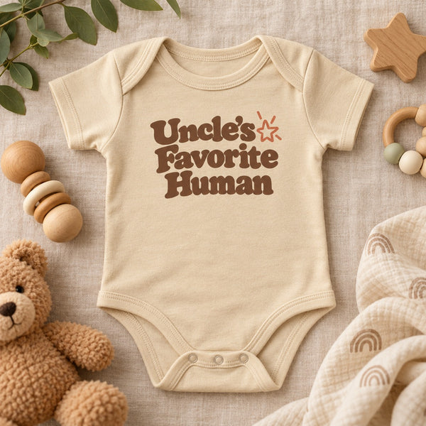 Styled flat lay of the Uncle's Favorite Human baby bodysuit