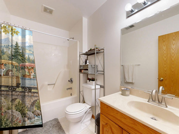 Animal Train shower curtain on a tub shower combo in an American family bathroom