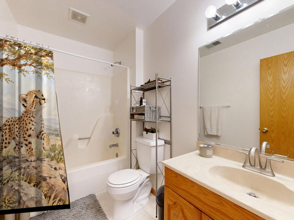 Cheetah Cub Safari shower curtain on a tub shower combo in an American family bathroom