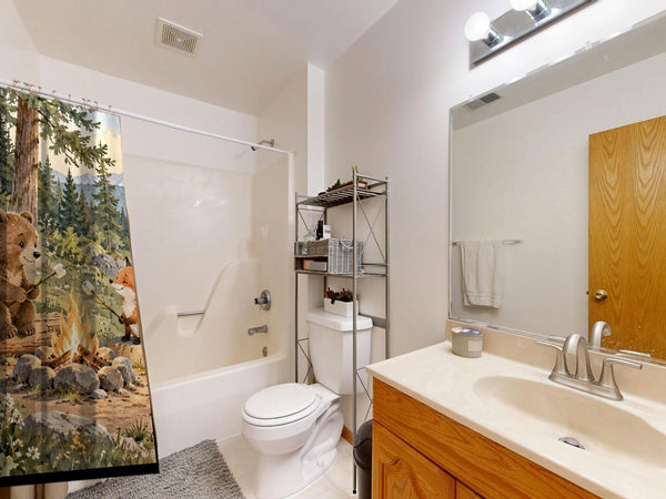 Bear and Fox Campfire Camping shower curtain on a tub shower combo in an American family bathroom