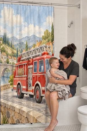 Mom holding her baby on the tub edge next to the Fire Truck Town shower curtain