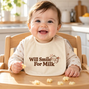 Will Smile For Milk baby bib in cream, styled photo 1