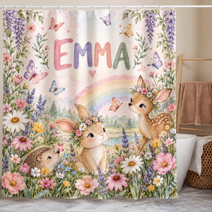 Personalized rainbow, bunny and fawn shower curtain with the name Emma hanging in a kids bathroom