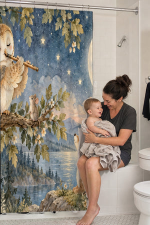 Mom holding her baby on the tub edge next to the Owl Flute shower curtain