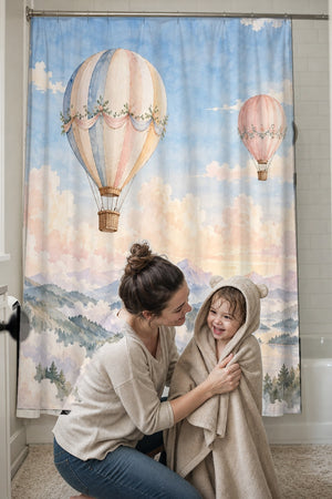 Mom drying her toddler in a hooded towel in front of the Mountain Hot Air Balloons shower curtain