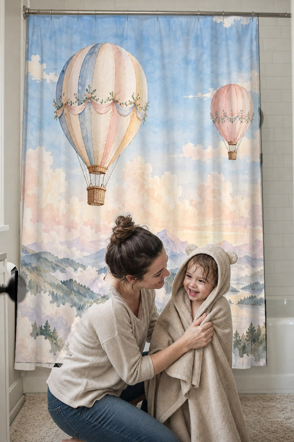 Mom drying her toddler in a hooded towel in front of the Mountain Hot Air Balloons shower curtain
