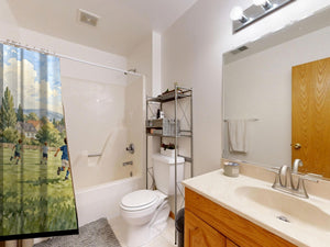 Kids Playing Soccer shower curtain on a tub shower combo in an American family bathroom