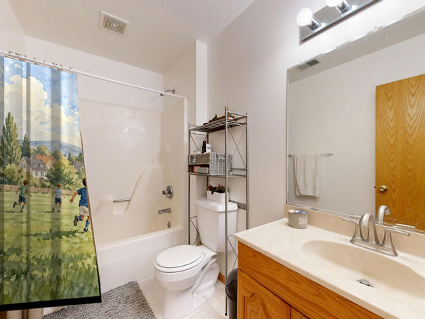 Kids Playing Soccer shower curtain on a tub shower combo in an American family bathroom