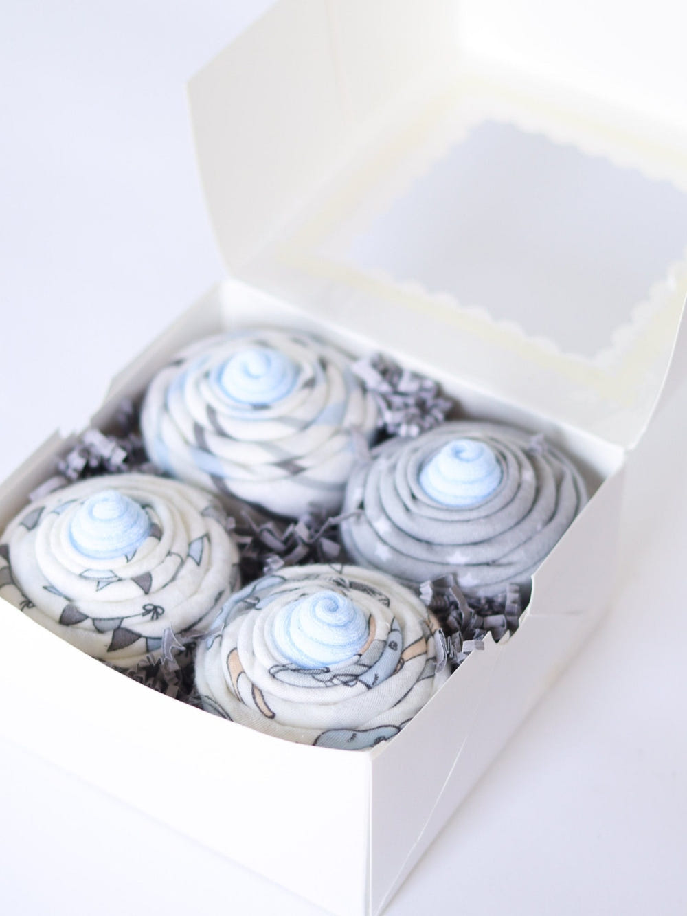 Baby Boy Cupcake Set - Royal Safari, featuring adorable animal designs on swaddles and baby blankets.