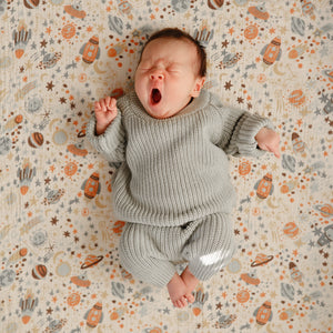 Baby chunky knit sweater in soft fabric, angled view showcasing cozy design and vibrant color. Perfect for chilly days.