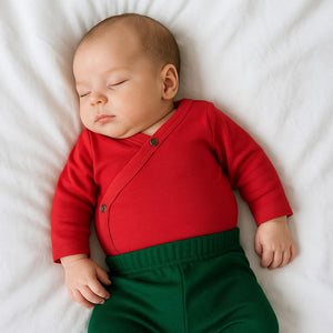 Scarlet red long sleeve bodysuit for babies, angle view showcasing soft fabric and stylish design.