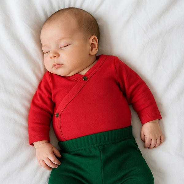 Scarlet red long sleeve bodysuit for babies, angle view showcasing soft fabric and stylish design.