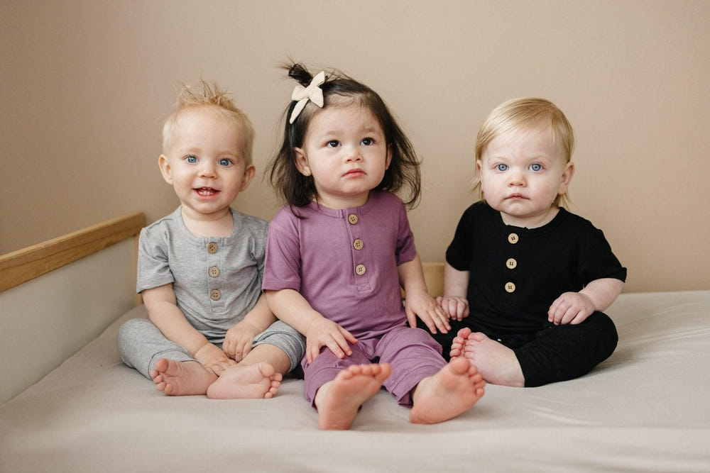 Bamboo Henley Romper for babies in soft, breathable fabric, perfect for comfort and style.