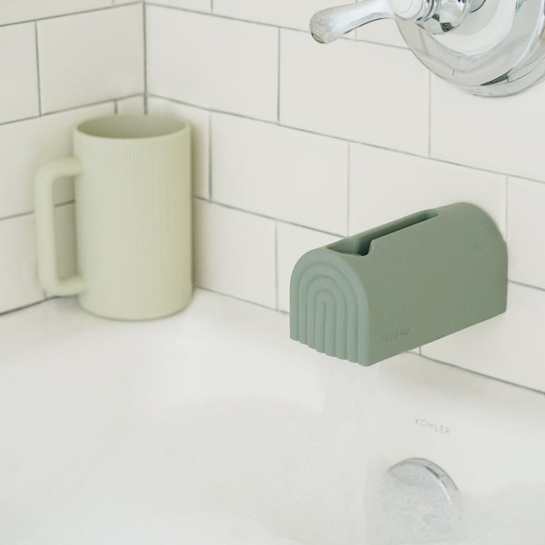 Colorful bath rinse cup for babies, angled view showcasing its ergonomic design and fun features.