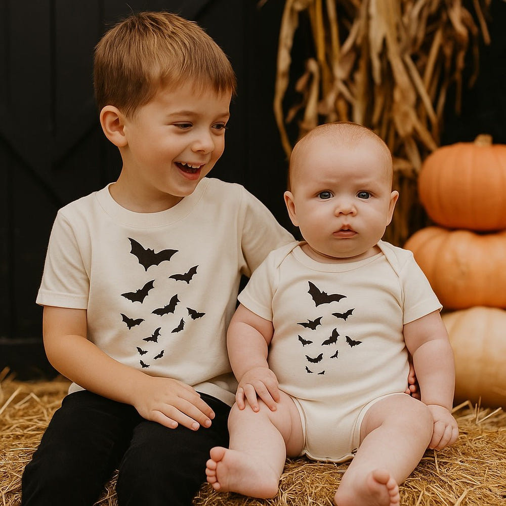 Cute short sleeve graphic bodysuit featuring playful bats for babies. Perfect for stylish and comfy outfits.