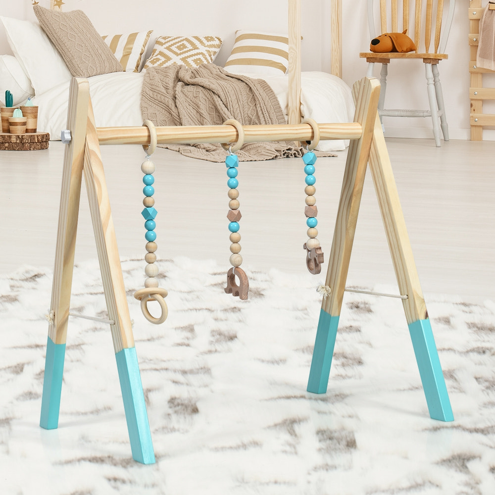 Portable wooden baby activity gym with teething toys and hanging bar for newborns. Ideal for playtime and development.