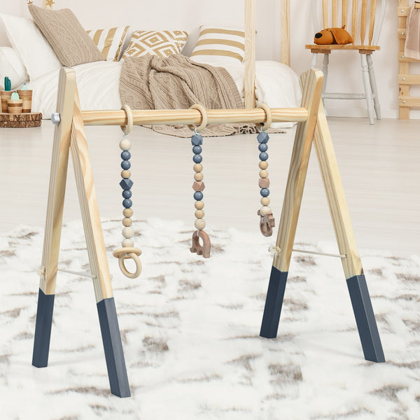 Portable wooden baby gym with teething toys, perfect for newborns, shown at angle 18.