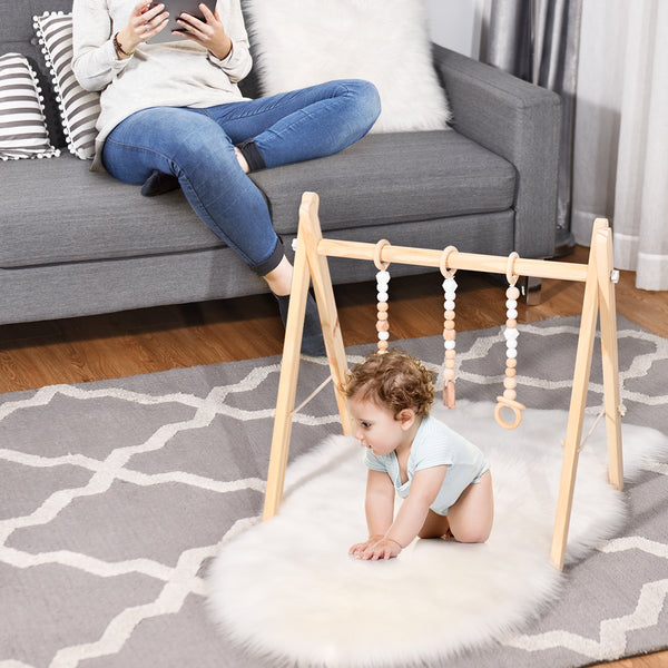 Portable wooden newborn baby gym with teething toys, hanging bar, and engaging activities for early development.