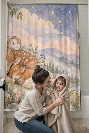 Mom drying her toddler in a hooded towel in front of the Dreamland Friends shower curtain