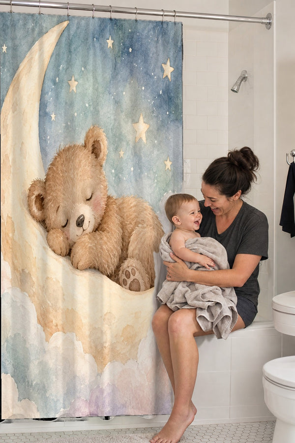 Mom holding her baby on the tub edge next to the Moon Bear shower curtain
