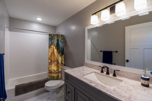 Moonlit Forest Camp Camping shower curtain pulled open in a gray kids bathroom