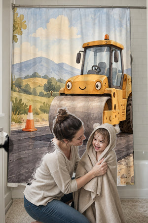 Mom drying her toddler in a hooded towel in front of the Road Roller shower curtain