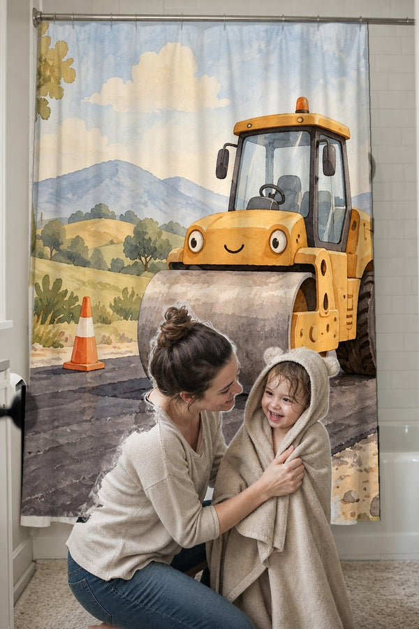 Mom drying her toddler in a hooded towel in front of the Road Roller shower curtain