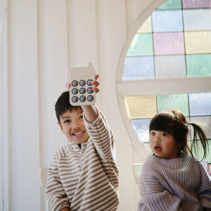 Colorful phone press toy for babies, designed to enhance sensory play and fine motor skills. Angle 9 view.
