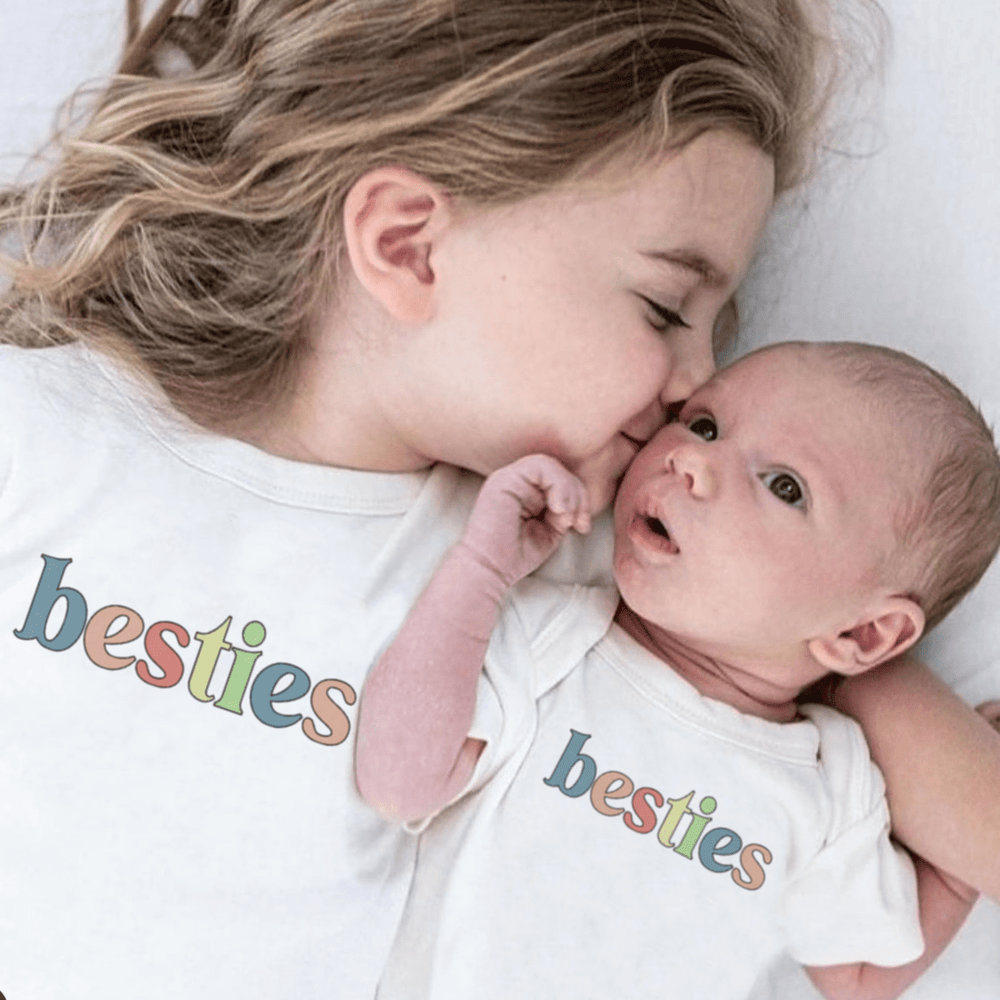Graphic bodysuit for babies featuring "Besties" design, perfect for stylish short sleeve wear.