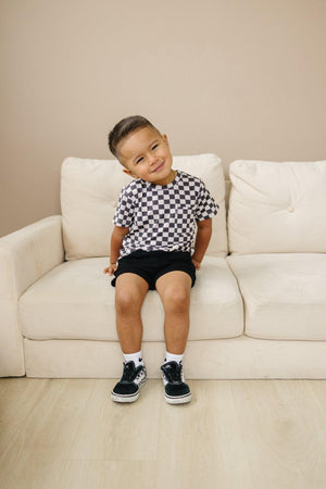 Black checkered bamboo tee for babies, stylish and comfortable, displayed at angle 7. Perfect for casual wear.