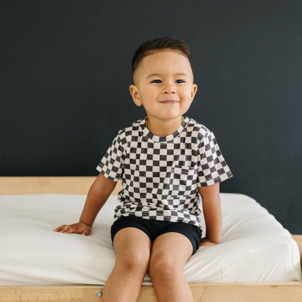 Black checkered bamboo tee for babies, stylish and comfortable top for everyday wear.