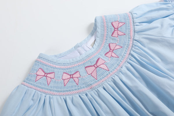 Blue and pink bow smocked romper for babies, stylish and comfortable, perfect for any occasion.