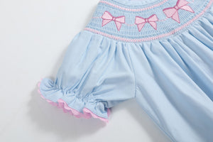 Blue and pink bow smocked romper for babies, perfect for stylish and comfortable playtime.