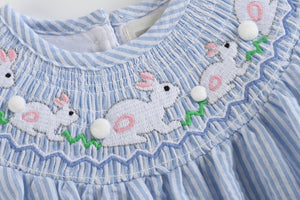 Blue seersucker bunny smocked flutter romper for babies, shown from angle 4, perfect for spring and summer outfits.
