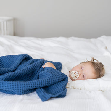 Soft waffle baby blanket in pastel colors, perfect for keeping your little one cozy and warm.