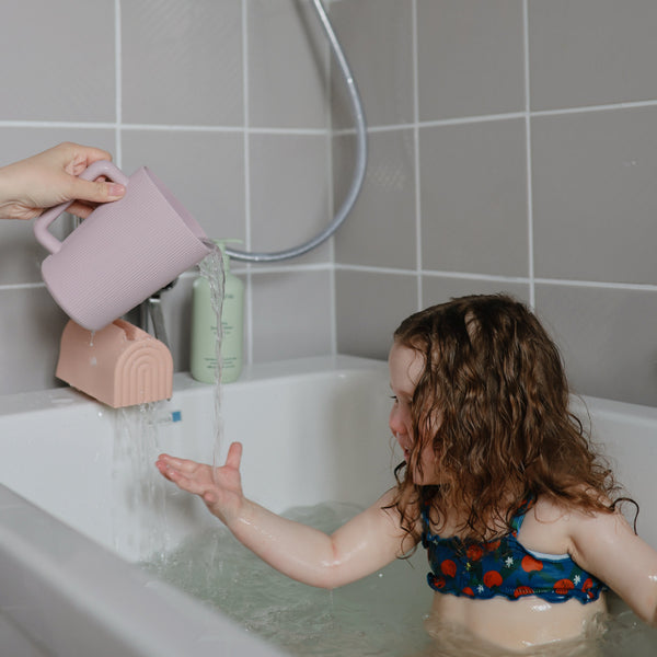 Colorful bath rinse cup for babies, angled view showcasing ergonomic design and easy grip for bath time fun.