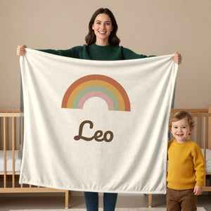 Boho Rainbow toddler minky blanket in cream, held by a mom