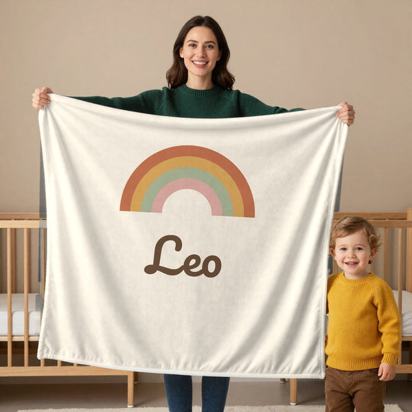 Boho Rainbow toddler minky blanket in cream, held by a mom