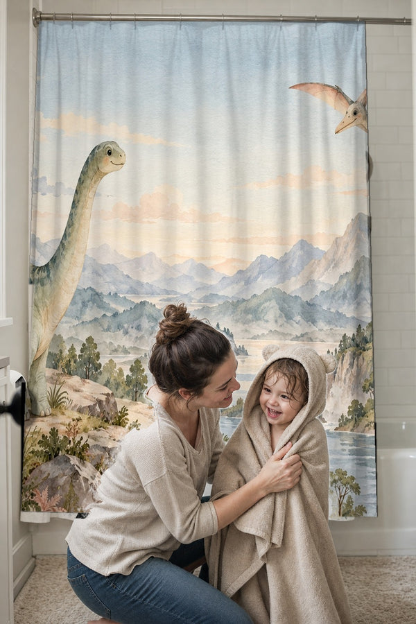 Mom drying her toddler in a hooded towel in front of the Mountain Dinosaur shower curtain