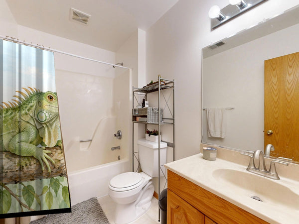 I is for Iguana Alphabet shower curtain on a tub shower combo in an American family bathroom