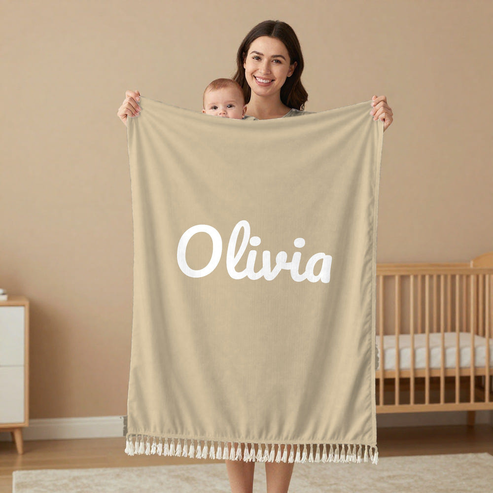 Classic Name woven baby name blanket in sage, held by a mom