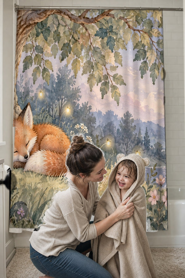 Mom drying her toddler in a hooded towel in front of the Sleepy Fox shower curtain