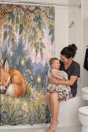 Mom holding her baby on the tub edge next to the Sleepy Fox shower curtain