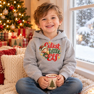 Child wearing the Cutest Little Elf toddler hoodie at Christmas