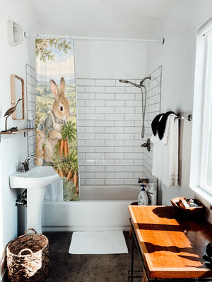 Bunny Garden Farm shower curtain hanging on the rod over a white bathtub