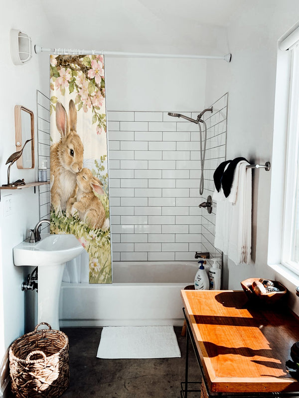 Apple Blossom Family Bunny shower curtain hanging on the rod over a white bathtub