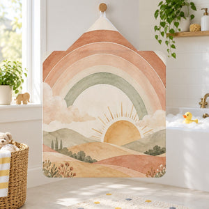 Rainbow Sunrise Hills kids hooded bath towel hanging in a kids bathroom