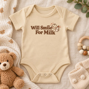 Styled flat lay of the Will Smile For Milk baby bodysuit