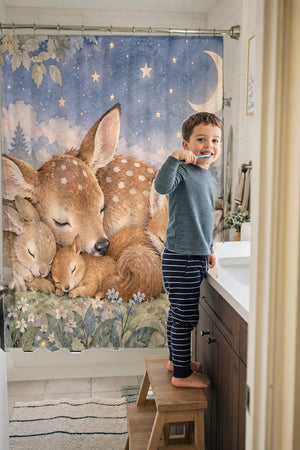 Child brushing teeth in a family bathroom with the Woodland Friends shower curtain