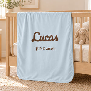 Name and Birth Month swaddle blanket in sky, styled photo 1